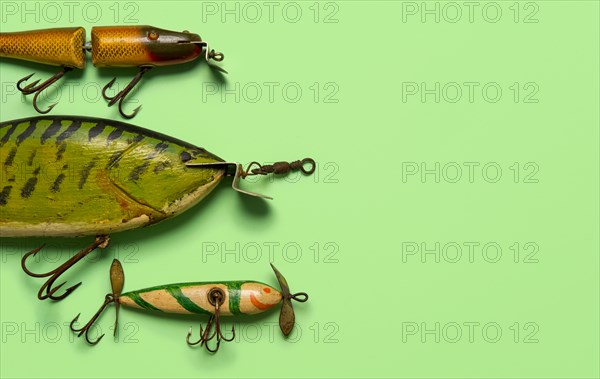 Antique fishing lures on green background