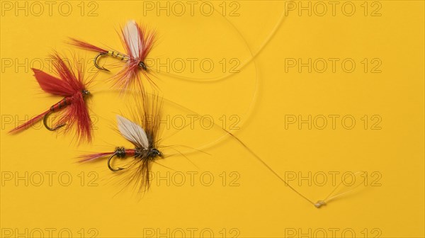 Antique fishing lures arranged on orange background