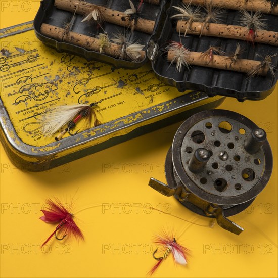 Vintage fishing tackle on yellow background