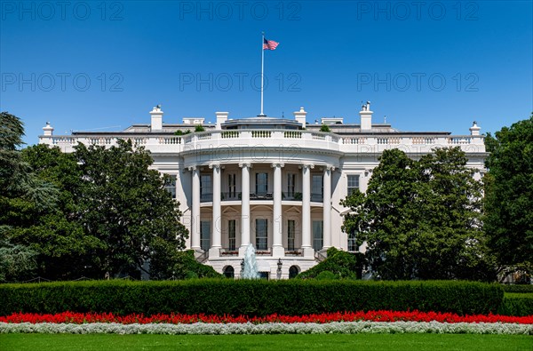 USA, Washington D.C., White house with green grass and summer sky