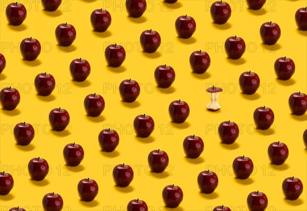 Large group of red apples on yellow background
