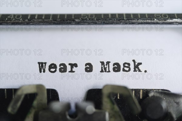 Typewriter text reading wear a mask