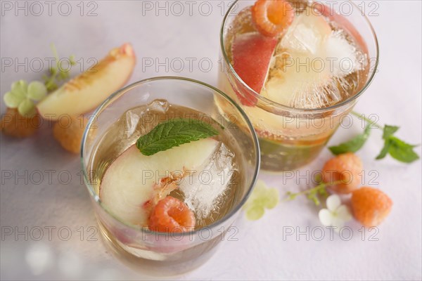 Peach cocktail with fresh raspberries