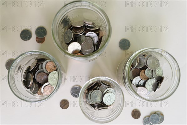 Jars with money on white background