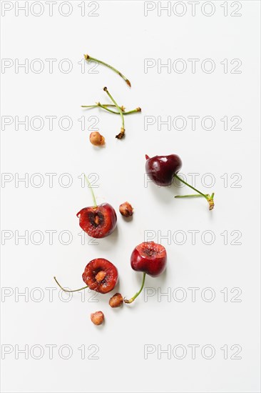 Eaten cherries on white background