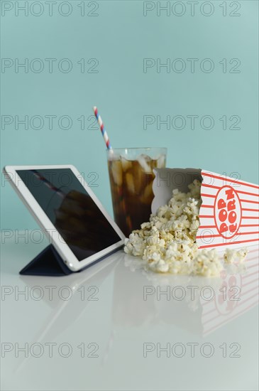 Studio shot of popcorn with digital tablet and soda