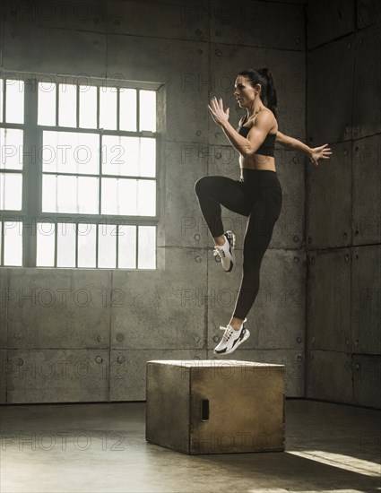 Woman exercising in warehouse