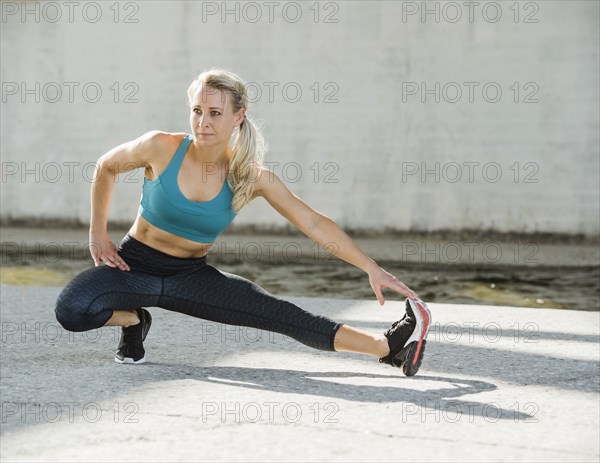 Sporty woman stretching outdoors