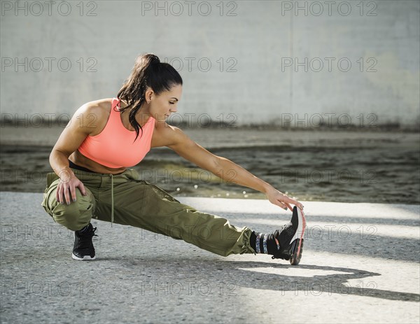 Sporty woman stretching outdoors