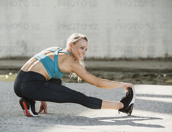 Sporty woman stretching outdoors