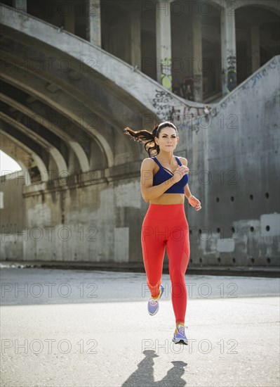 USA, California, Los Angeles, Sporty woman jogging in urban setting