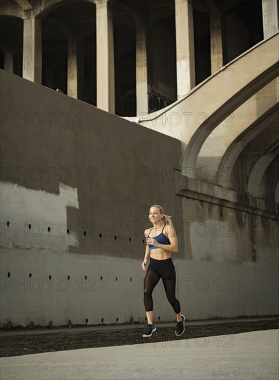 USA, California, Los Angeles, Sporty woman jogging in urban setting