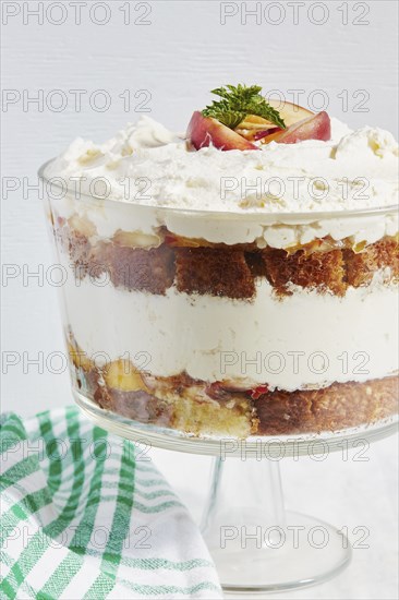 Trifle dessert with whipped cream and peaches