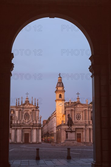 Italy, Piedmont, Turin, Town square with church and statue seen though gate