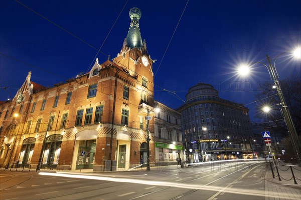 Poland, Lesser Poland, Krakow, Illuminated street and buildings in historic city district