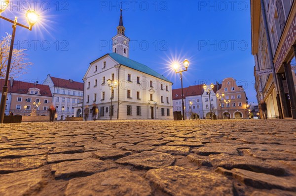 Poland, Silesia, Gliwice, Illuminated town square with cobblestone