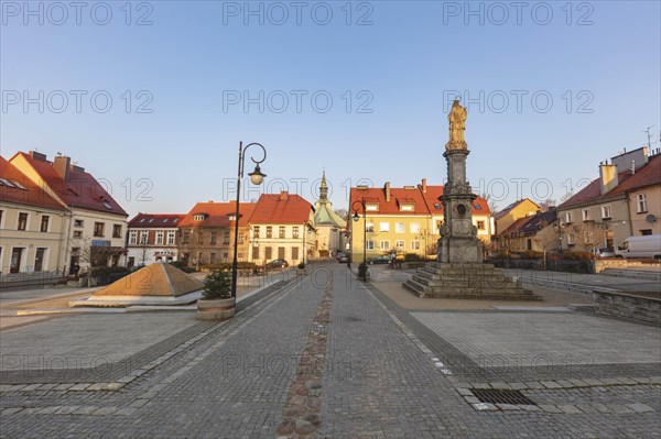 Poland, Opole, Toszek, Historic town square with statue at dusk