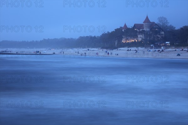 Poland, Pomerania, Leba, Castle at Baltic Sea coast at dusk