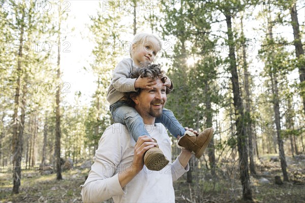 Father carrying little daughter