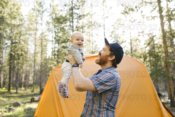 Father lifting baby boy