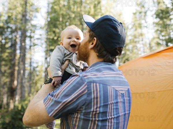 Man kissing baby son