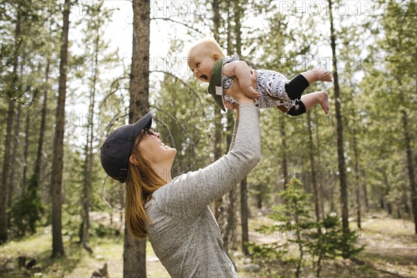 Smiling woman playing with baby son