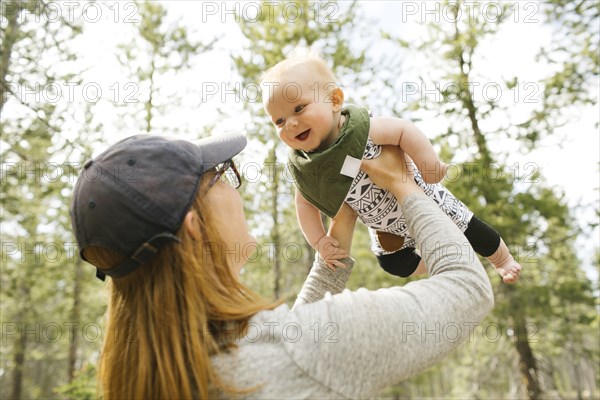 Smiling woman playing with baby son