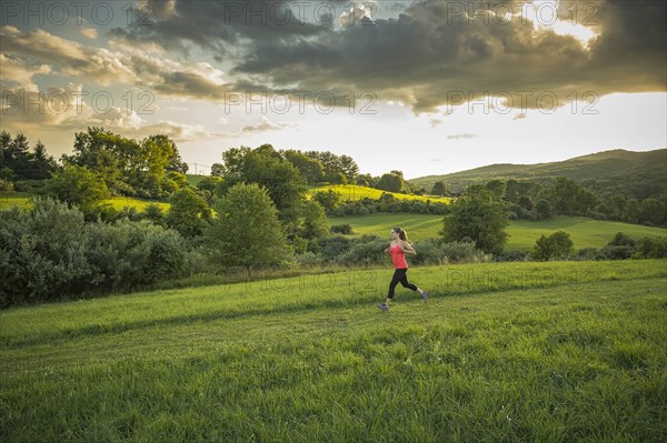 USA, Woman running in field