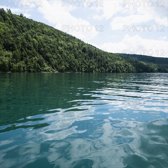 USA, New York, Cooperstown, Otsego Lake, Hill covered with forest at lakeside