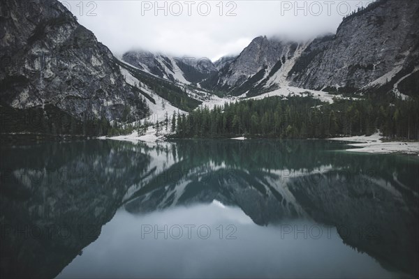 Italy, Pragser Wildsee, Dolomites, South Tyrol, Mountain range reflecting in lake