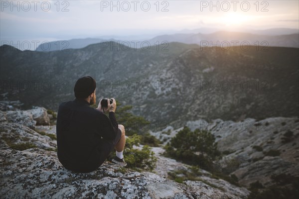 Italy, Liguria, La Spezia, Man looking at mountain range from mountain top