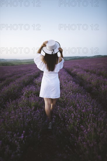 France, Woman in white dress in lavender field