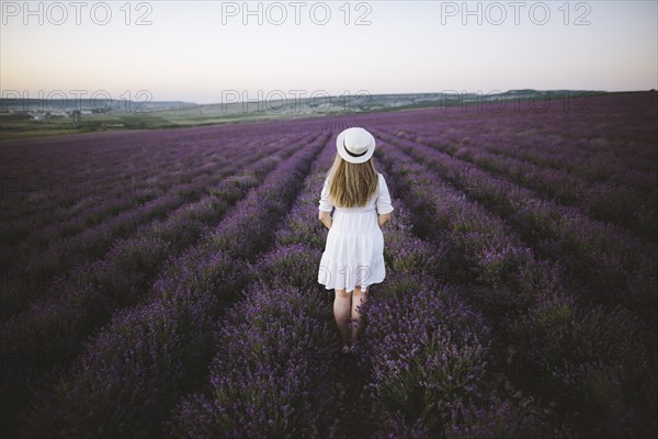 France, Woman in white dress in lavender field