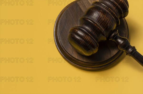 Gavel on yellow background