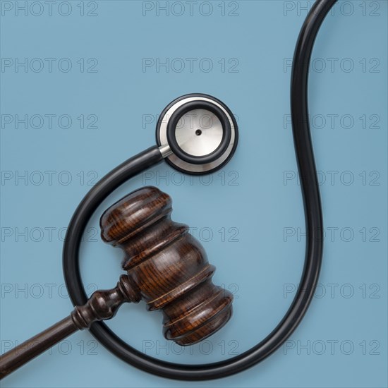 Gavel and stethoscope on blue background