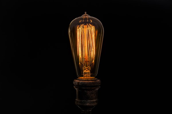 Edison light bulb on black background