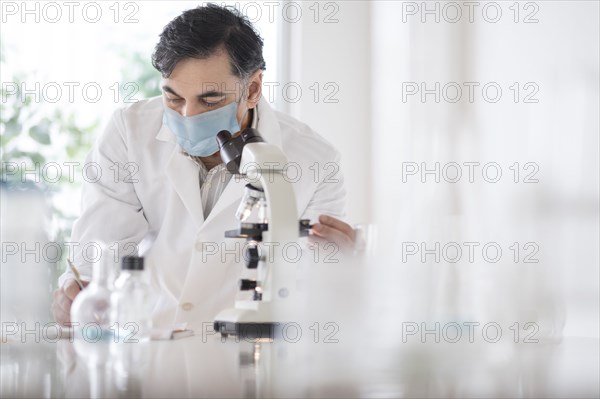 Doctor using microscope