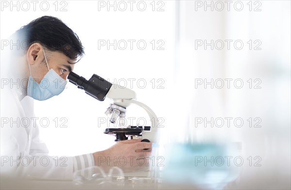 Doctor using microscope