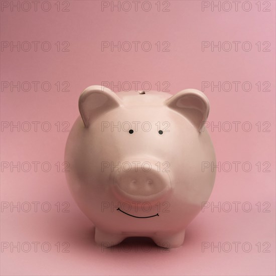 Piggy bank on pink background