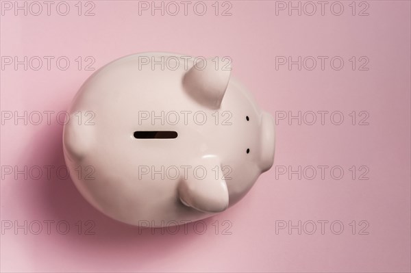 Piggy bank on pink background