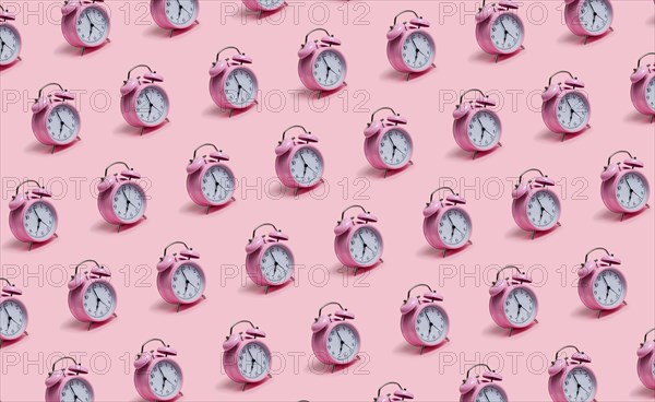 Alarm clocks on pink background