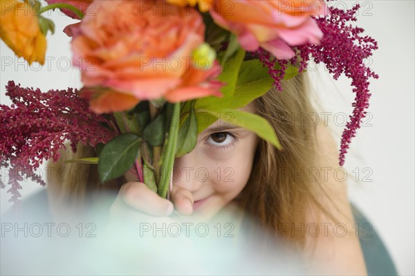 Girl (6-7) holding flower bouquet