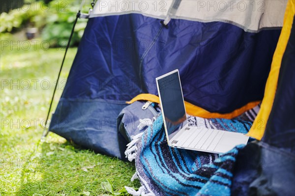 Tent and laptop in garden