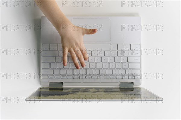 Boys (4-5) hand on laptop