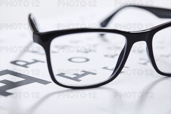 Close up of eyeglasses on eye chart
