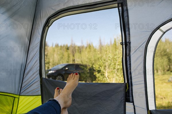 USA, Utah, Uinta National Park, Woman's legs in tent on camping