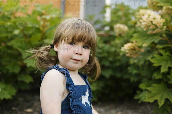 Portrait of toddler girl (2-3) in garden