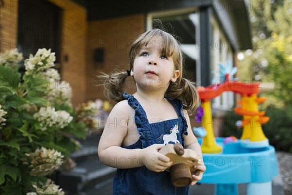 Portrait of toddler girl (2-3) in garden