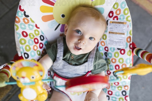 Portrait of baby boy (6-11 months) in baby bouncer