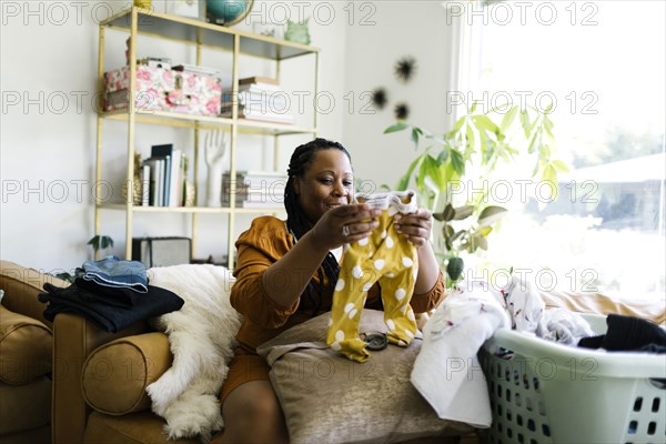 Woman folding laundry in living room